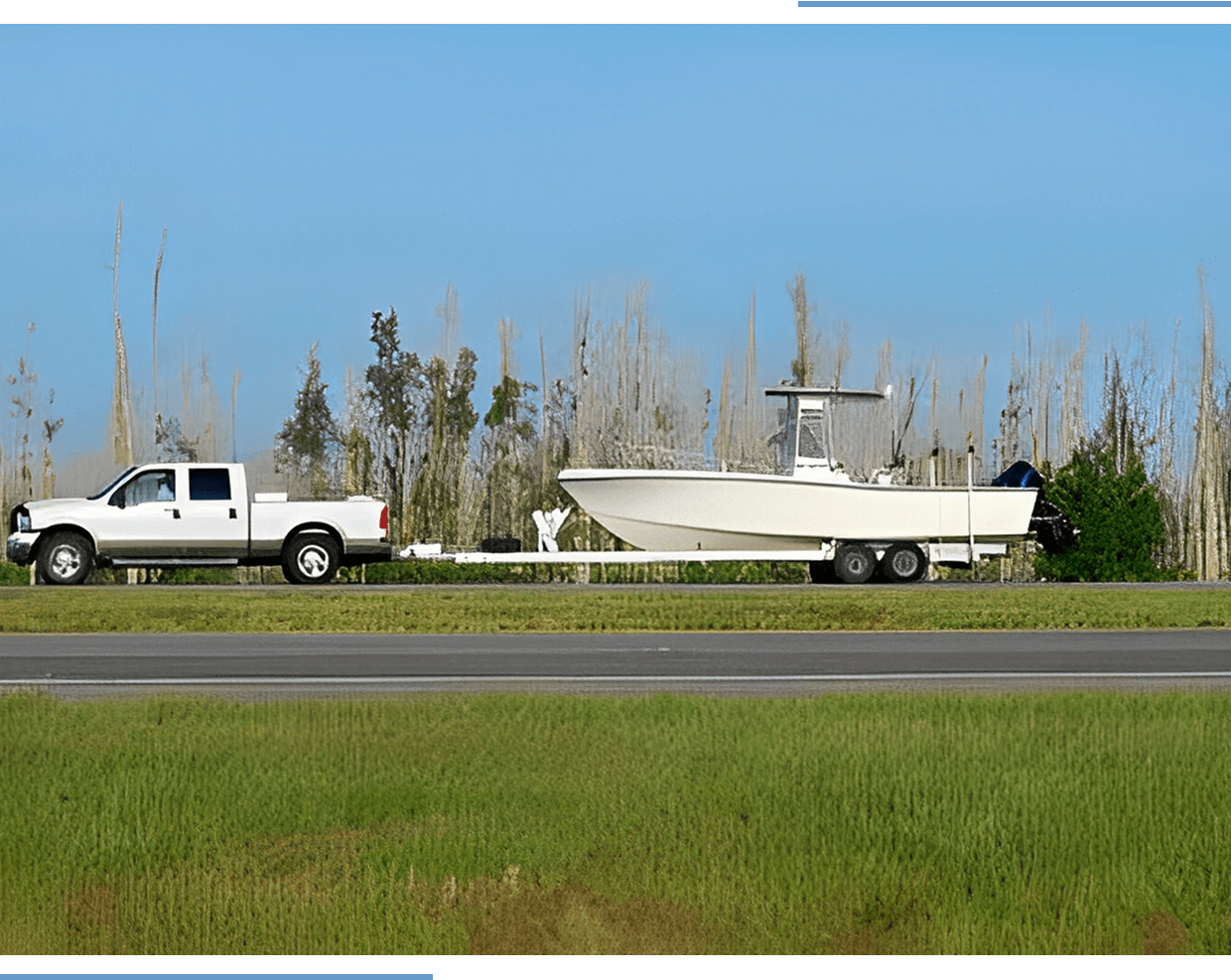 Truck towing a boat on a trailer.